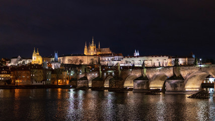 Castle of Prague cityscape at night with the lake and bridge in the front