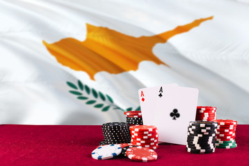 Cyprus casino theme. Aces in poker game, cards and chips on red table with national flag background. Gambling and betting.