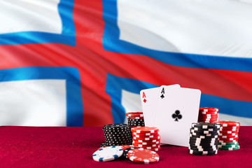 Faroe Islands casino theme. Aces in poker game, cards and chips on red table with national flag background. Gambling and betting.