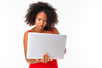 Serious african female works with laptop, picture isolated on white background