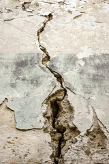 Vertical big crack on an old brick wall. Several of deep cracked line. Close up. Copy space.