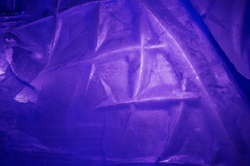 Ice with purple backlight. Spectacular background image. Copyspace.
