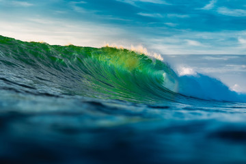 Perfect barrel wave in ocean. Breaking green wave with light