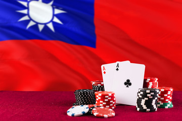 Taiwan casino theme. Aces in poker game, cards and chips on red table with national flag...