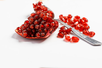 Fresh ripe pomegranate on white background, Spoon with fresh pomegranate seeds.