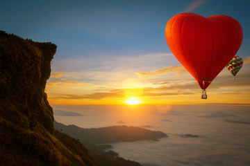 Fototapeta na wymiar Heart shape hot air balloon fly over Phucheefah mountain
