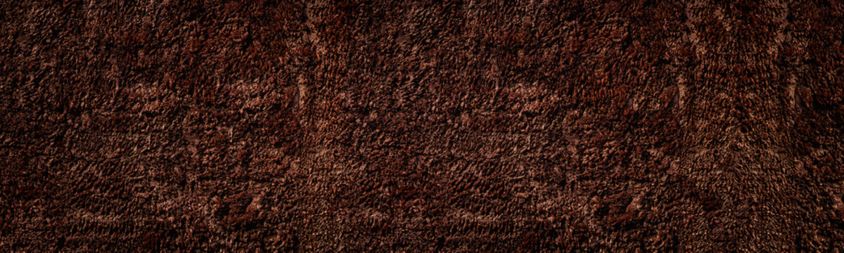 Rough bronze colored surface widescreen background. Dark cement plaster wide texture