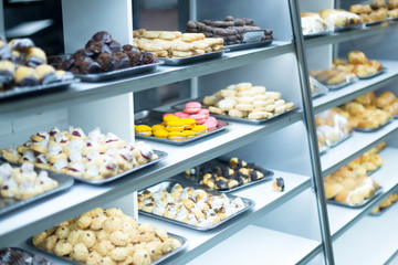 sweet culinary products under a glass counter in a store