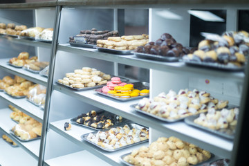sweet culinary products under a glass counter in a store