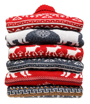 Stack Of Folded Knitted Christmas Turtleneck Sweaters On White Background