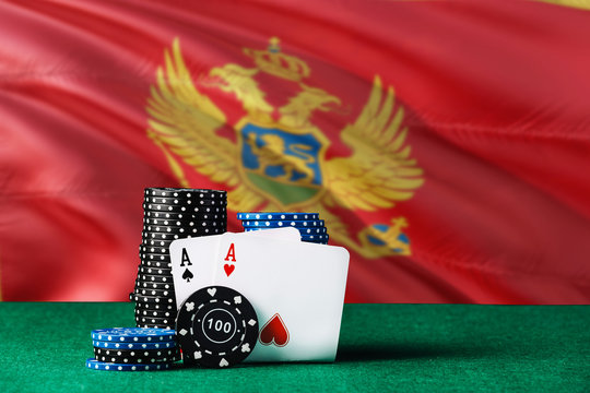 Montenegro Casino Theme. Two Ace In Poker Game, Cards And Black Chips On Green Table With National Flag Background. Gambling And Betting.