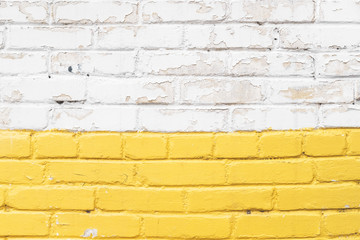 Yellow and white brick wall texture background. Old weathered and cracked bricks close up. Copy space