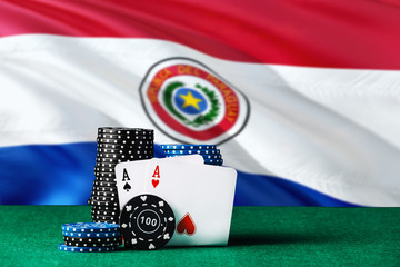 Paraguay casino theme. Two ace in poker game, cards and black chips on green table with national flag background. Gambling and betting.