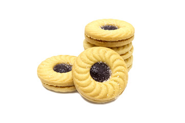 Biscuit sandwich butter cookies with cream and Blueberry flavoured jam. A stack of crunchy delicious sweet meal and useful cracker. isolated on white background. Soft focus.