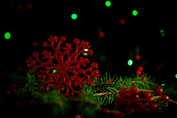 Christmas toys, with green Christmas tree on dark background with lights