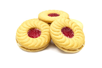 Biscuit sandwich butter cookies with cream and strawberry flavoured jam. A stack of crunchy delicious sweet meal and useful cracker. isolated on white background. Soft focus.