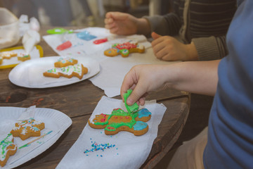 Children decorate gingerbread cookies on Christmas Eve