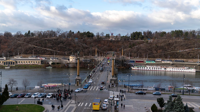 czech bridge prague with traffic an ships on the river