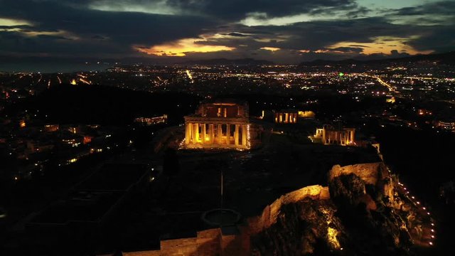 Aerial drone video of illuminated Acropolis hill and Masterpiece Parthenon with beautiful colours at dusk, Athens, Attica, Greece