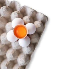 Concept healthy food, Fresh duck eggs and yolk in eggshell on paper tray on yellow background-top view