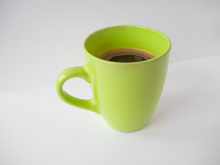 Green cup of coffee on white background 