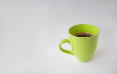 green cup of coffee on white or gray background, top view, copy space