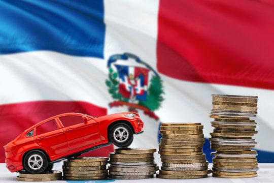 Dominican Republic savings concept. Money for new automobile, toy car and coin piles standing on national flag background. Copy space for text.