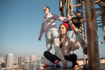 Young friends looking away on the rooftop