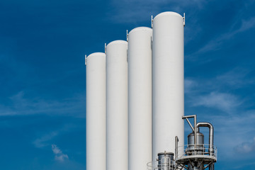 White Concrete Tank Silo industry with Blue sky in background