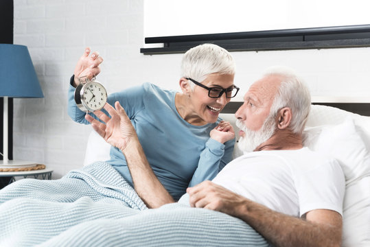 Senior couple waking up - Powered by Adobe