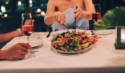 Young woman with a dinner on beach