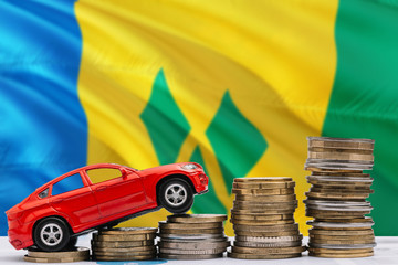 Saint Vincent And The Grenadines savings concept. Money for new automobile, toy car and coin piles...