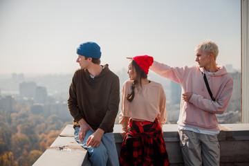 Young guy showing hand to side on the roof