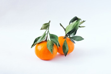 Tangerine on white background. Tangerine or Clementine with green leaves isolated on white background