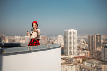 Happy Asian female winking at the camera on roof