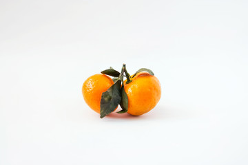 Tangerine on white background. Tangerine or Clementine with green leaves isolated on white background