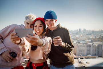 Smiling young girl winking at the camera on rooftop