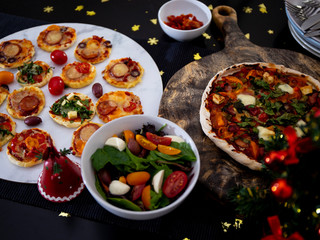 Home made pizza and mini pizza on the table