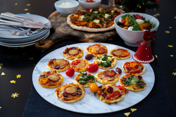 Home made pizza and mini pizza on the table