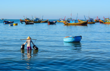 Women with traditional hats working at village