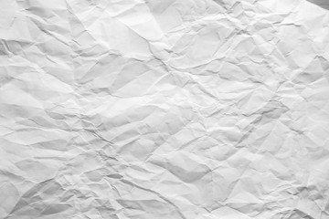 Crumpled sheet of white paper. Textured background.