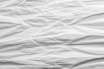 Crumpled sheet of white paper. Textured background.
