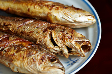 3 grilled fishes on white plate