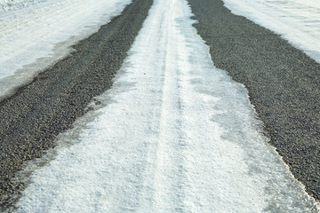 winter asphalt road covered ice crust. snow covered driveway