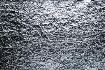 Crumpled sheet of aluminum foil. Embossed texture.
