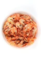 Boiled shrimps in a container on white background