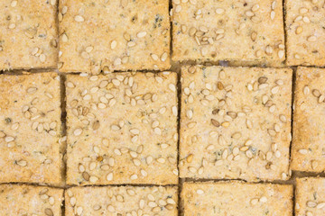 background of crispy spelt and chickpea cracker with sesame