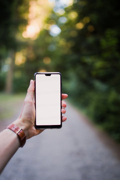 Man holding a smart phone, white flat screen mockup