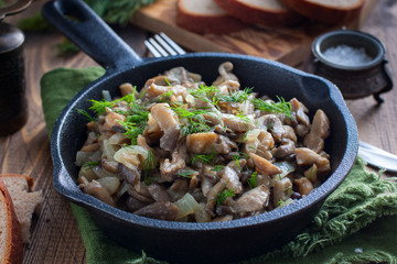 Fried oyster mushrooms in a cast-iron pan, selective focus