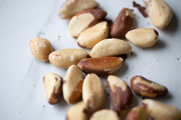 Brazil nuts on white marble background
